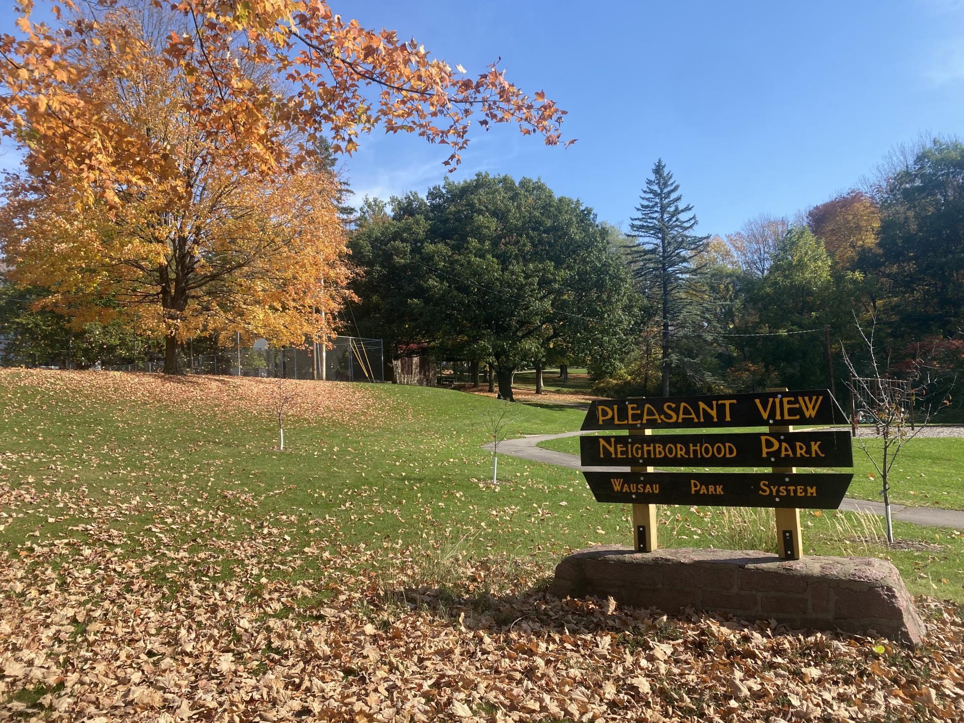 park sign in the park with trees changing colors